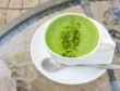 Closeup a cup of matcha latte or green tea on glass table background
